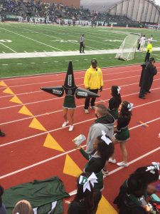 Cheer team on the sideline.