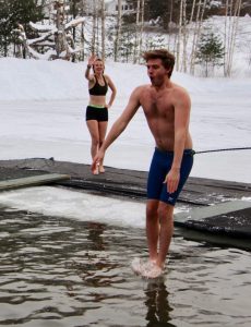 man jumping into freezing water
