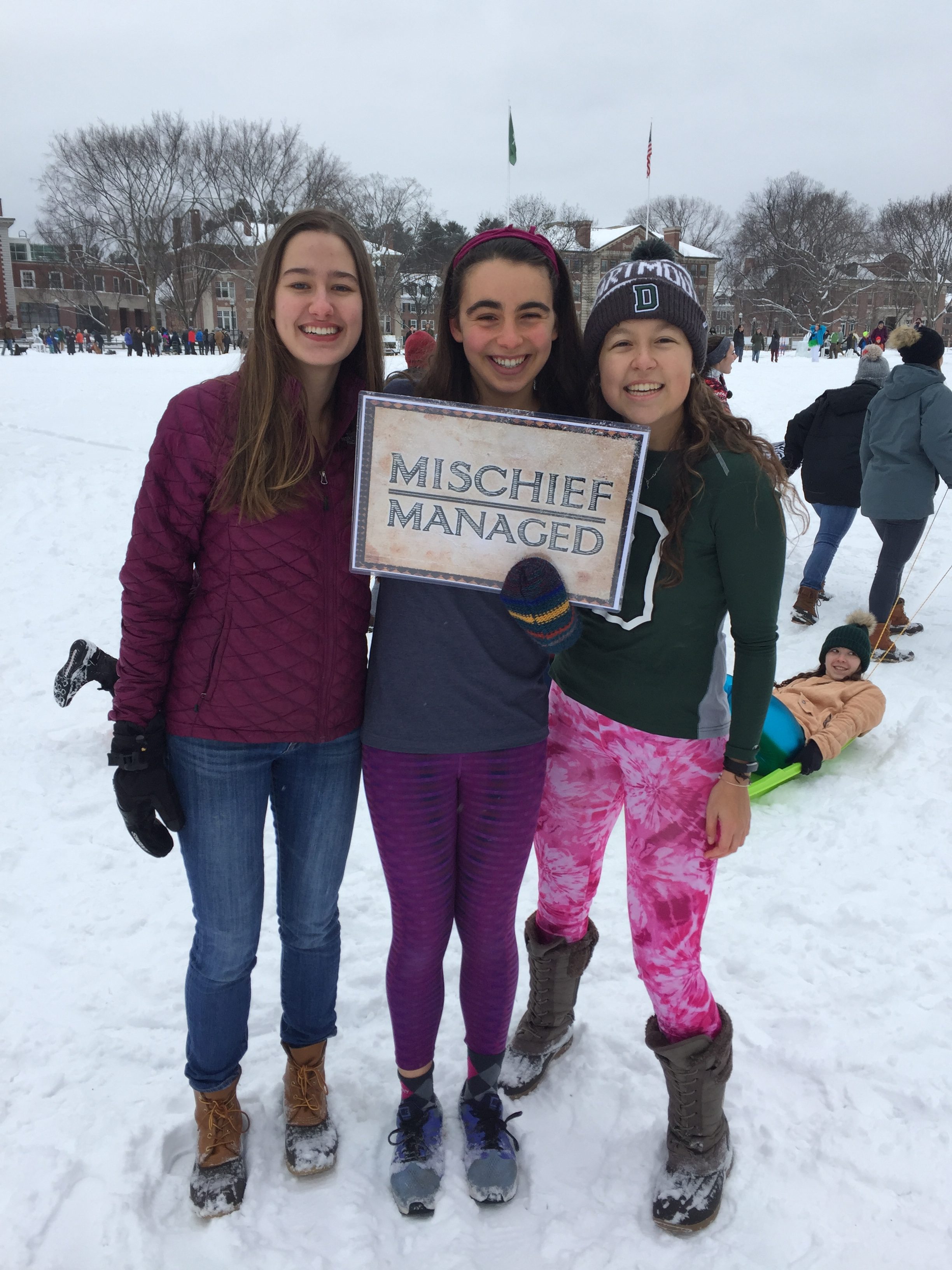 Three students with "Mischief Managed" sign