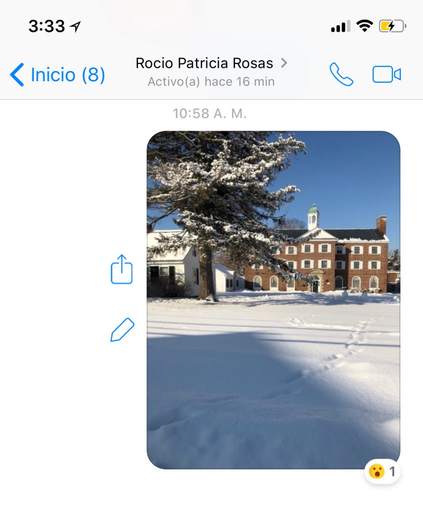 Screenshot of a text message with a picture of campus covered in snow.