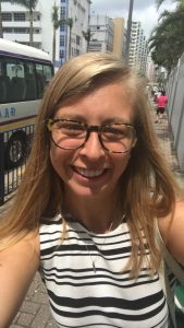 selfie of a young woman with blonde hair and glasses in downtown Hong Kong