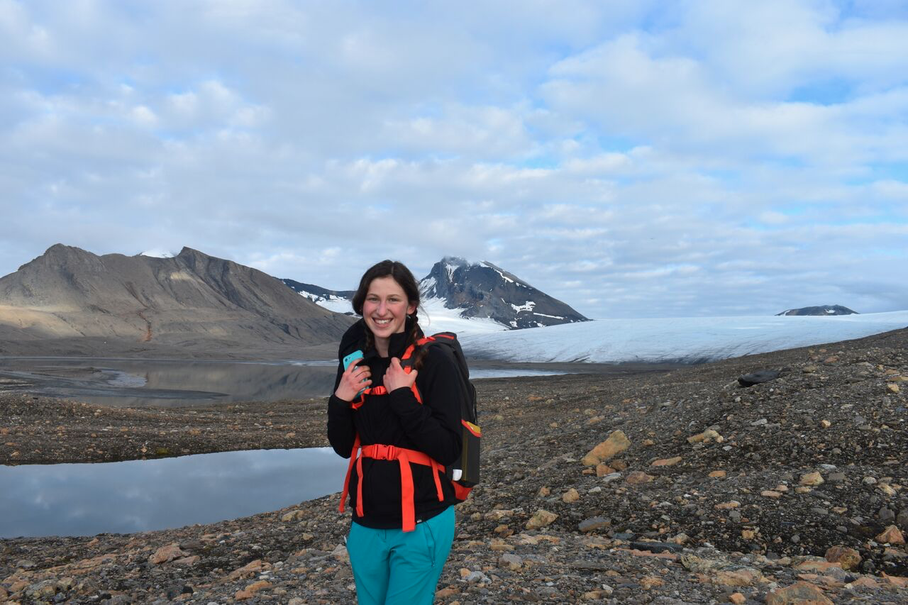 girl with backpack before Arctic mountains