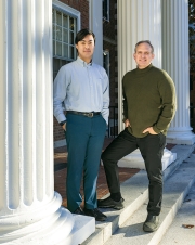 A photo of Carson Goh '25 and Jason Barabas '93 standing in front of white columns