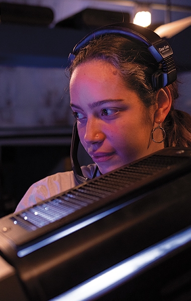 A photo of a member of the stage crew wearing a headset on the set of Pippin
