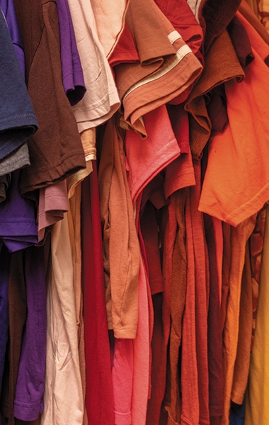 A photo of tshirts sorted by color at Dartmouth's Free Market on-campus thrift store