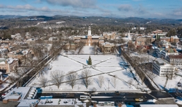 A photo of Dartmouth's campus in winter taken by a drone looking north at Baker-Berry Library and hills beyond campus