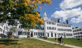 A photo of Dartmouth Hall with students going to classes