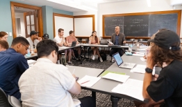 A photo of professor Devin Singh in a classroom with students
