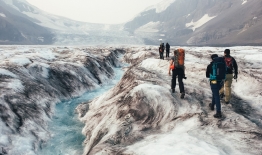 A photo of students in the Stretch program hike up the Athabasca Glacier in the Canadian Rockies to collect GPS data useful for measuring glacier velocity.