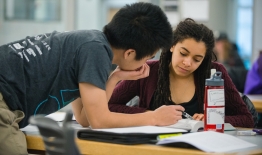 A photo of two students working on papers