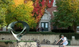 A photo of students in front of Wilder Hall, which is covered with ivy that has changed to reds and oranges in autumn