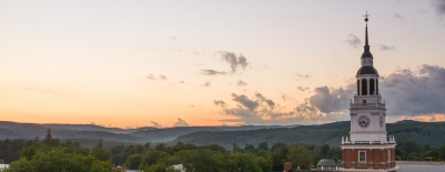An image of Baker Tower looking southwest at the setting sun