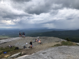 Summit of mountain with rain clouds in background