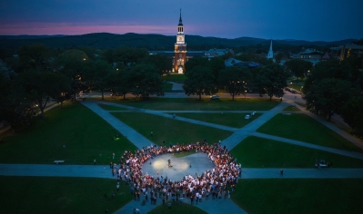 A photo of the Dartmouth Green with people gathered to remember Buddy Teevens '79, the Robert L. Blackman Head Football Coach
