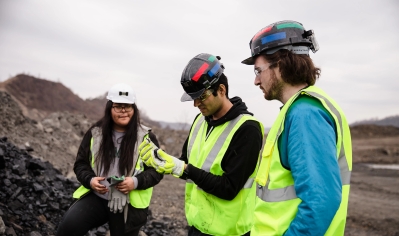 A photo of Ashley Laveriano '24, Hamza Najam '26, and Angus McReynolds take a closer look at some coal at the Maple Eagle complex, operated by Blackhawk Mining.