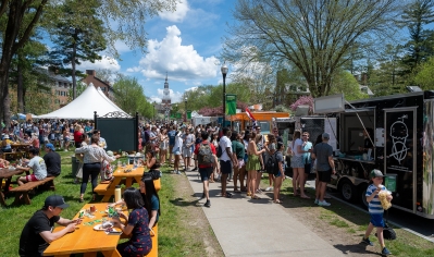 A photo of many students at an outside event with food trucks as part of the Innovation Festival