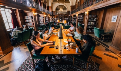 A photo of students studying in the Tower Room of Baker Library