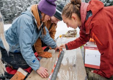 A photo of students measuring sediment core