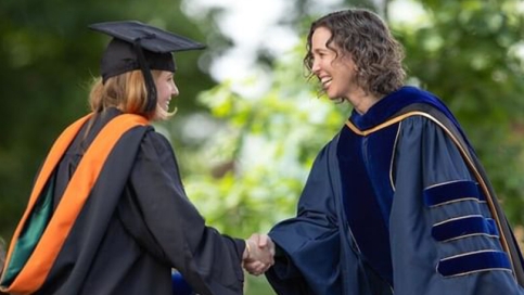 A photo of Dean Alexis Abramson congratulating a graduate