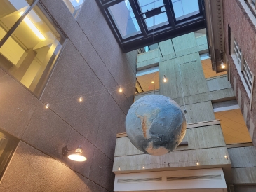 A globe hanging from the ceiling shut from below