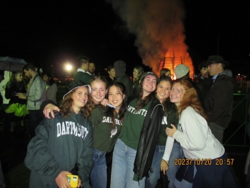 Group of friends in front of homecoming fire