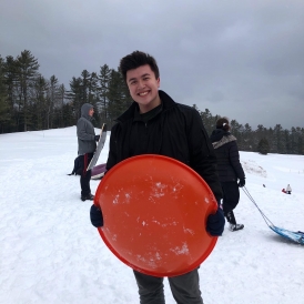 Gabe in the snow armed with a sled