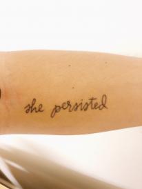 tattoo reading "she persisted" 