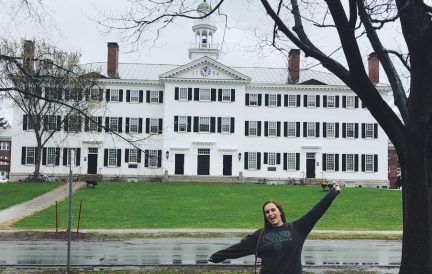 Abbi in front of Dartmouth Hall on a rainy day
