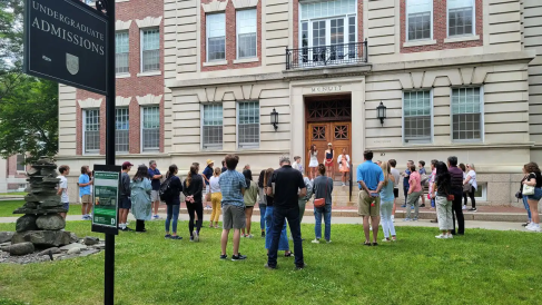 A photo of a group of people in front of the Dartmouth Admissions Office.