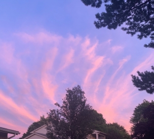 Picture of a suburban house with a purple-pink sunset