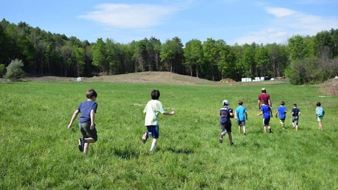 Upper Valley children running with a Dartmouth Student mentor