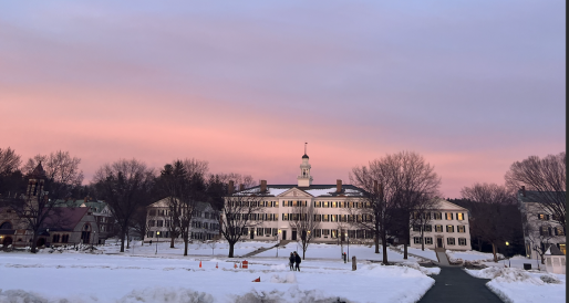 Picture of a white building, Dartmouth hall, in the winter during sunset