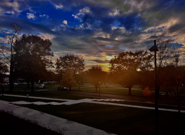Sunset: warm colors, cool breeze. The green pictured from Dartmouth Hall steps which is a wide angle of the campus.