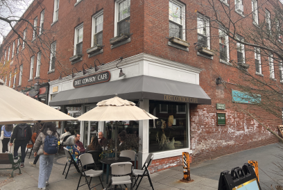 Entrance of Dirt Cowboy, a cafe on the ground floor of a red brick building