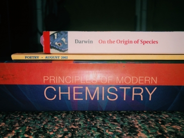 My books for this quarter! A chemistry, poetry, and natural history book stacked on top of each other