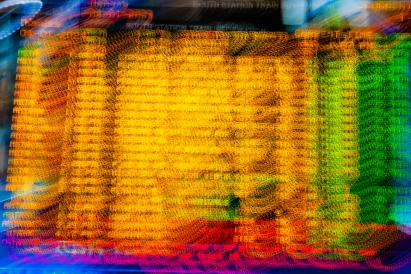 Distorted train timetable in Boston South Station.