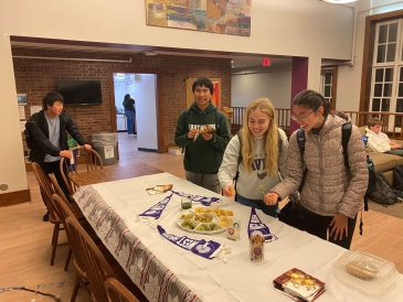 A picture of students eating the mochi donuts that I made for UGA Snacks night.
