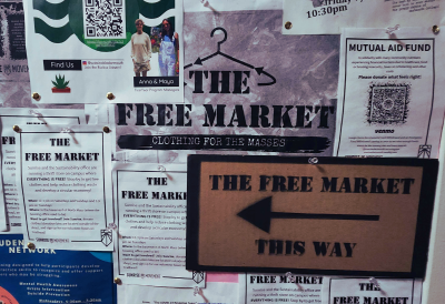 A bulletin board with a bunch of posters saying, "Free Market". 