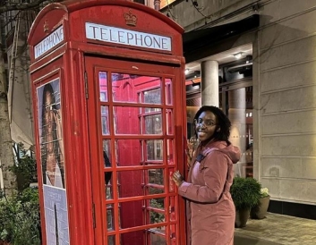 A picture of me outside a red London telephone booth