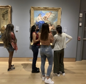 people looking at a painting