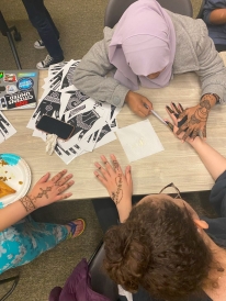 A picture of my friend and other girls getting their henna done at a Chand Raat on campus.
