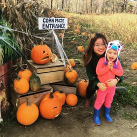 autumn posing with young girl in pumpkin patch