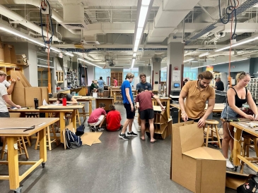 Dartmouth students constructing cardboard chairs in the Couch Lab