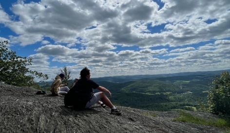 Gabriel and friends sitting on overlook on Wrightʻs Mountain