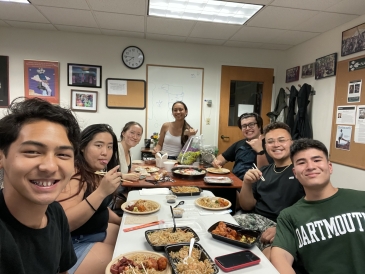 Image of Dartmouth Hokupa'a eating a catered dinner in the Native American Program lounge