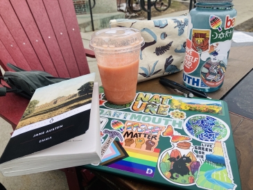 A Collis Smoothie, my laptop, a pencil pouch, and a copy of Jane Austen's Emma