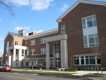 A student passes by the Haldeman building outdoors on a warm sunny day. Image from Dickey website.