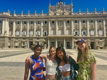 Lily and three other students from her program in front of the the royal palace in Madrid