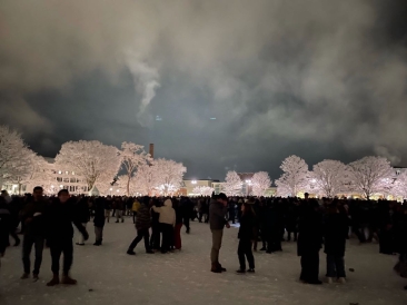 The Green during the annual snowball fight filled with hundreds of people playing in the snow at midnight