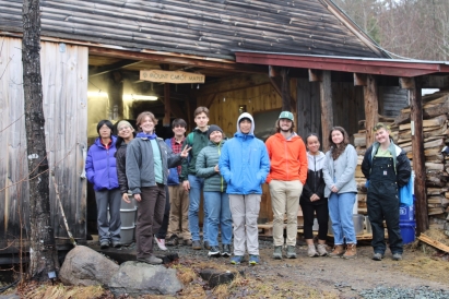 Group photo of Sugar Crew in front of a sugar shack. 